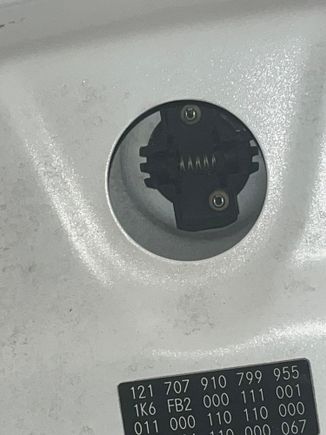 Opening in the hood to access the badge. I used needle nose pliers to remove it 