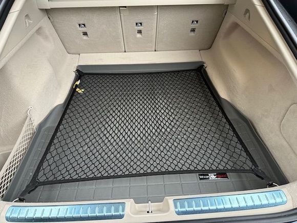 This is my setup: a black cargo net from my old Porsche Panamera and a gray Weathertech cargo liner. Very handy!!!