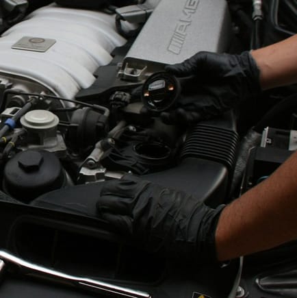 Loosen the oil cap with 17mm socket if needed. Removal of oil cap is important to improve flow.