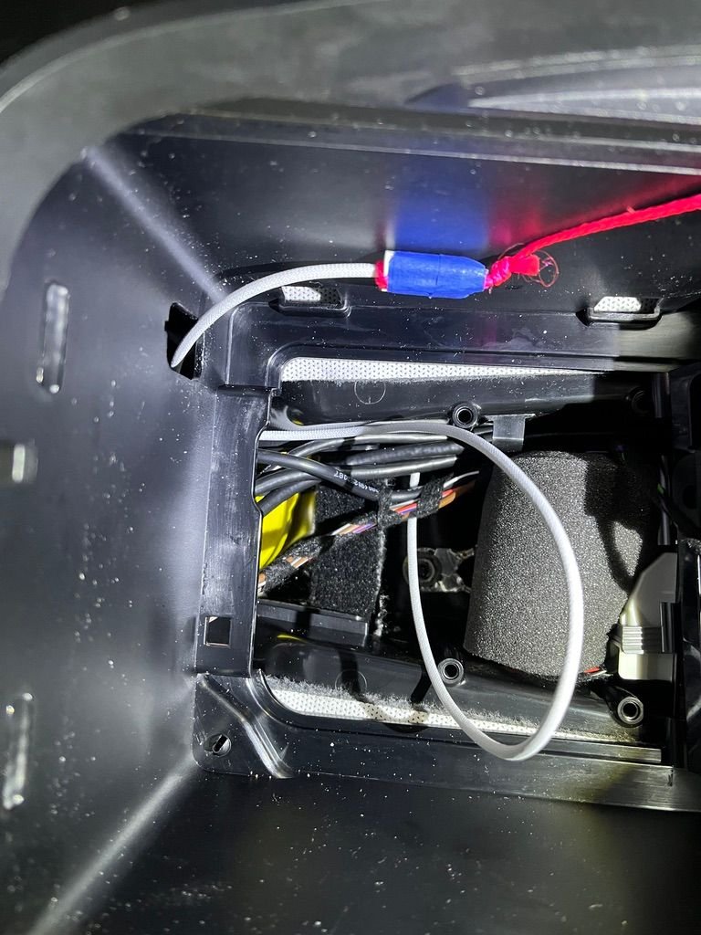 Routing cable above cup holder tray.