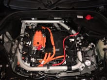 Under the bonnet, the mounting frame, coolant lines and HV cabling. The SE comes with a Heat Pump hopefully allowing for more efficient winter driving. 