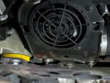 Power steering fan housing with openings for C-clip nuts.