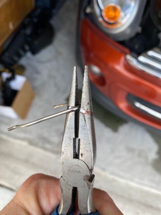 The clip that holds the thermostat housing to the cross-over tube to the intake of the coolant pump is almost impossible to get back on.  So I carved some notches into a needle nose pliers to help me maneuver the clip into place. 