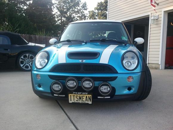 2003 Electric Blue R53, Hella driving and fog lights along with daytime LEDs.  Removed the factory fog lights and fit the brake duct cooling hoses in their place.