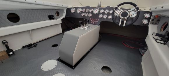 Cleaned up a lottle..i made a trim molding out of aluminum and powder coated it black for the console base.. this will tue in with the seat bases.