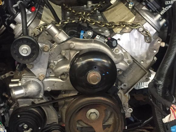 New engine in and bolted down at 12:15, spent almost the entire time between removal and installation, figuring out the harness i need to build and the connector that isnt available, and transferring ac compressor, water pump and ground strap.... And manuevering the engine and trans through the shop to the truck.....