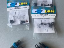 These are threaded truck shock bodies with blue aluminum threaded adjusters (2 per shock to lock them down). New seals/cartridges.  