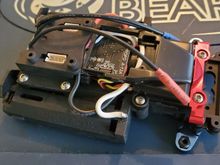 I just cut down the EVO cover and screw it to the chassis.  It holds the receiver in place and I've had no issues.