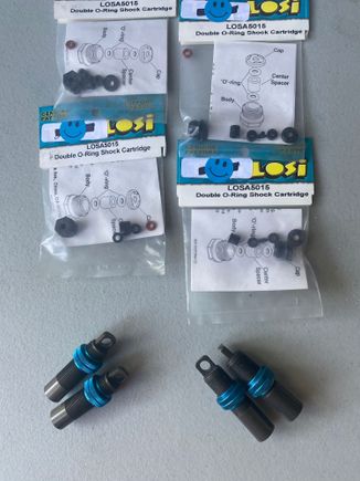 These are threaded truck shock bodies with blue aluminum threaded adjusters (2 per shock to lock them down). New seals/cartridges.  