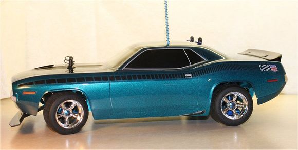 Kyosho Turbo Optima Onroad Build: Re-engineered as a narrowed-track onroad 4WD car with HPI 1970 'Cuda body &amp; vintage series wheels; Pactra CheZoom Teal paint.

Details:

 -Kyosho Turbo Optima w/belt drive conversion
 -Aluminum parts polished &amp; anodized
 -Alloy top deck from pargu2000
 -Hobbywing 35A ESC; Futaba S3003 servo (swapped out Castle Sidewinder ESC for another car)
 -SpeedPassion Sport-Tuned v2.0 17.5T 2500 kV motor
 -HPI VTA wheels &amp; tires, 1970 AAR 'Cuda body
 -1488 grams w/body, clips; no battery

Mods &amp; hop-ups:

 -Alloy turnbuckles, 4.8mm ball studs &amp; ball cups throughout
 -Kyosho TF-3 billet front control arms; Spider front CVD's
 -GPM DF02 rear control arms #2056
 -MIP HPI RS4 Shiny CVD bones #1182 mated to Lazer LA245 CVD axles
 -Duratrax Maximum steering knuckles #DTXC9953
 -Duratrax DTXC8100 chrome outdrives
 -3Racing Lazer ZX-5 rear hub/carriers #ZX5-18/V2/BU
 -3Racing Lazer ZX-5 shock set #ZX5-01/BU
 -Associated MMGT blue shock springs #25544
 -Tamiya blue alloy stabilizer balls #53644 w/4.8mm Delrin ball-ends
 -Custom-made graphite front shock tower
 -Custom-made Kydex front bumper
 -Kyosho 3mm thin hexes (front)
 -Golden Hobbies 1/16 E-Revo hexes (rear) customized for 2mm thick cross-pins
 -RCScrewz stainless steel screw set
