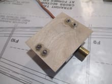 The adjustable aluminum servo bracket is held to the plywood mount with four 2-56 blind nuts.
