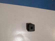 This is one of four rubber grommets that were supplied with this servo.  At first glace they may all appear identical (which they are) but the can be installed in the wrong orientation.  If you look carefully you will notice that the top and bottom widths of the grommet are not the same.  Remember that divider that I spoke of?  The smaller width should go on top.  If you put it in upside down the grommet will not sit correctly.   It's easy to miss. I've seen many servos with the grommets install