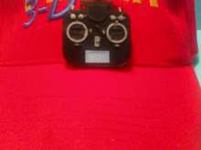 This mini transmitter mounts with a very strong magnet so you don't have to make holes in your hat.  Great Christmas present for you flying buddies or club drawings too!