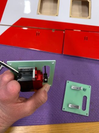 Using JR 1" Servo horns and they will work great for the build.  Perfectly centered in the slot and the 2mm stock hole works with the stock hardware.