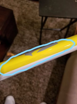 The black is showing through the yellow paint on the leading edge