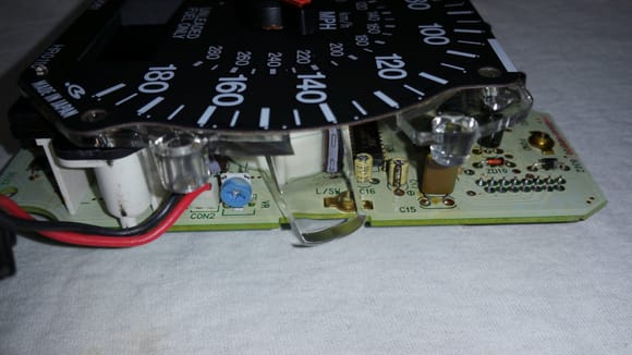 Side view of speedometer with VR (blue Phillips head).  VR is the speedometer adjustment potentiometer.