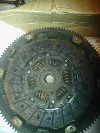 old clutch disc laying on flywheel