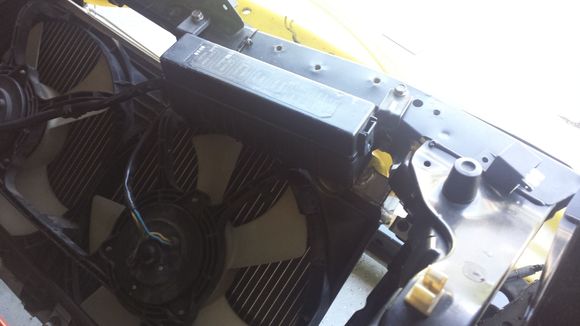 Here's a shot of the tight fit with the relay box - radiator needs to go lower, but that ain't happening unless I do a bit of grinding on the bumper reinforcement - not an option!