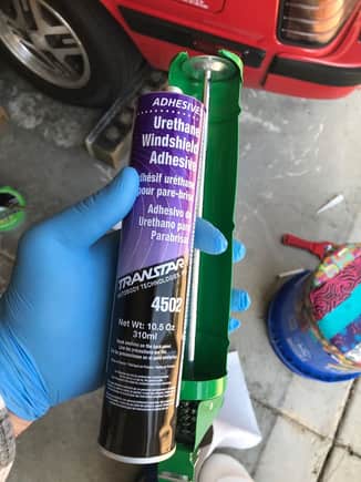 The adhesive for replacing the glass.  This stuff is THICK!  I put it on the dashboard of my truck and rotated it a few times to get it warm while I did other work.