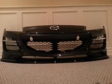 A mustach trim with some custom oil cooler screens and lip on a freshly painted front bumper