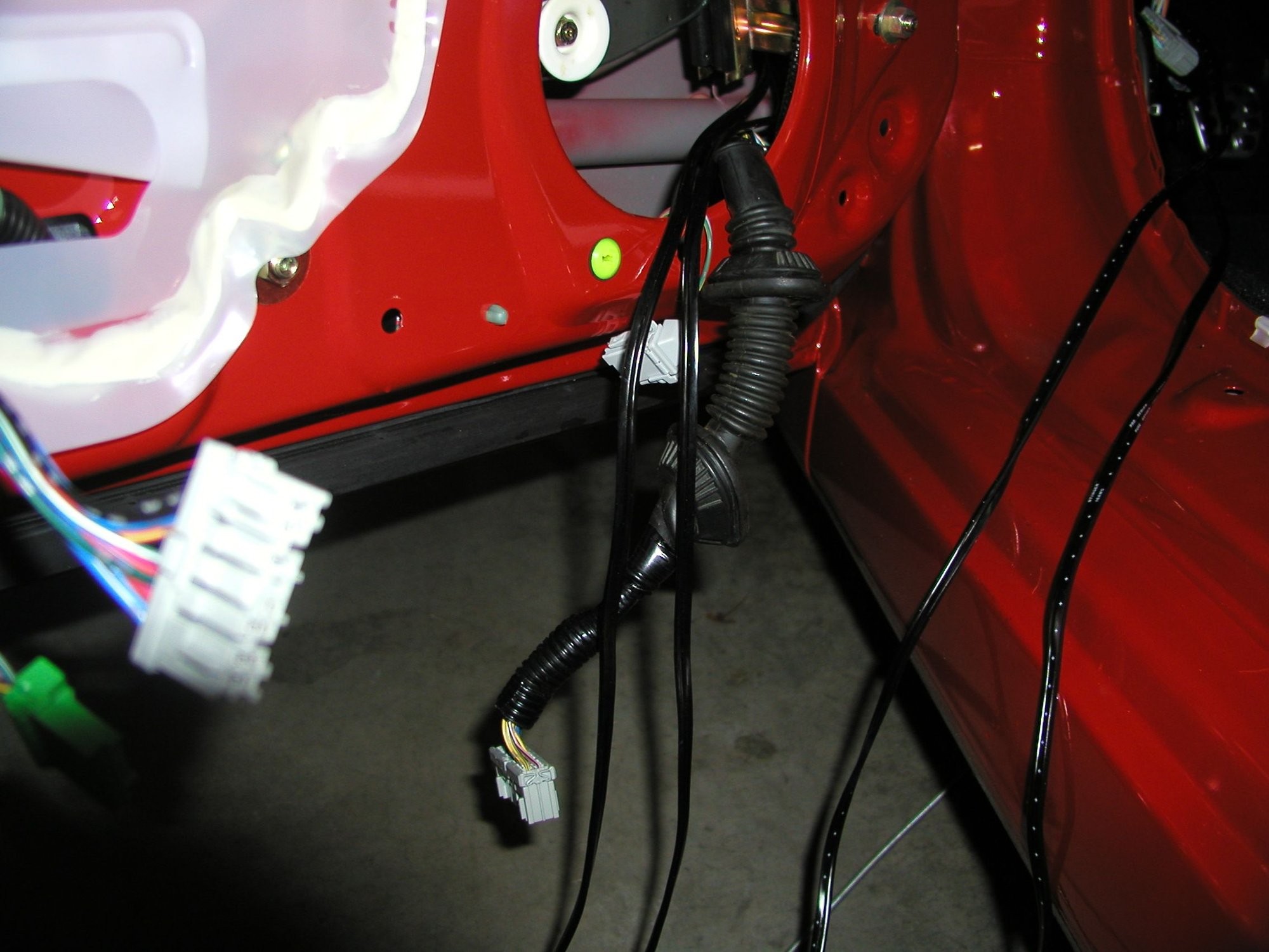 Now feed the speaker wire (x2) through the holes and into the door. You should now hav something like this: