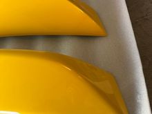 Slight cosmetic differences. The bottom is OEM, top is aftermarket. The lines are sharper on the aftermarket. The angles are also more pointier. 