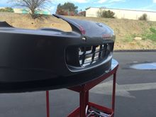 Splitter and air dam installed onto bumper cover, sitting on table