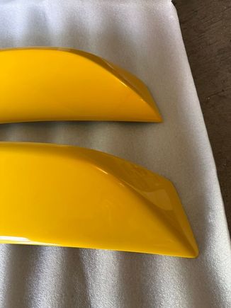 Slight cosmetic differences. The bottom is OEM, top is aftermarket. The lines are sharper on the aftermarket. The angles are also more pointier. 