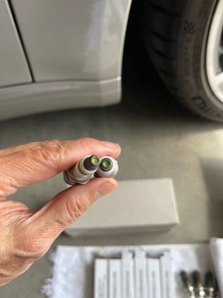 Looking at these old plugs, I don't believed the dealer replaced them during the first major service.  The green tip usually indicated it was factory installed.  