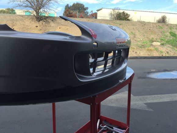 Splitter and air dam installed onto bumper cover, sitting on table