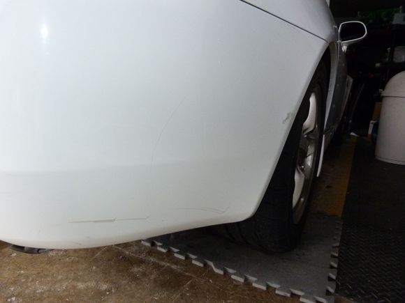 rear bumper marks and a scuff just behind the wheel
