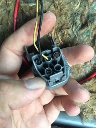 The wire will go into the connector through the back as shown.