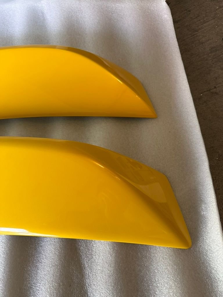 Slight cosmetic differences. The bottom is OEM, top is aftermarket. The lines are sharper on the aftermarket. The angles are also more pointier. 