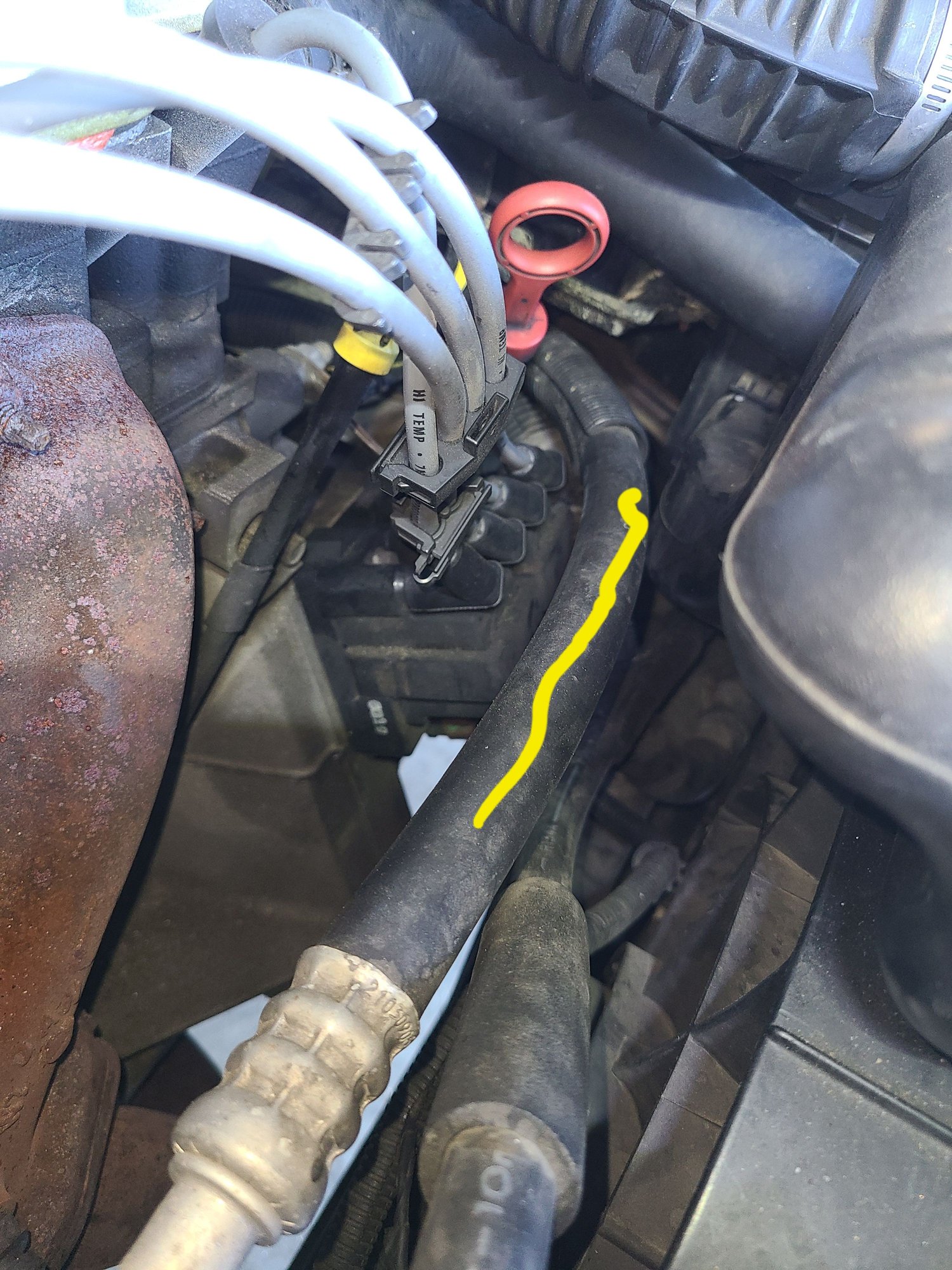 Starting from the compressor (just off camera at bottom of picture), the suction hose routes in front of the oil and transmission fluid dipsticks.