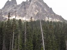 Liberty Bell Mountain towers over Washington Pass. The mountains in the area are all made of gold colored granite.