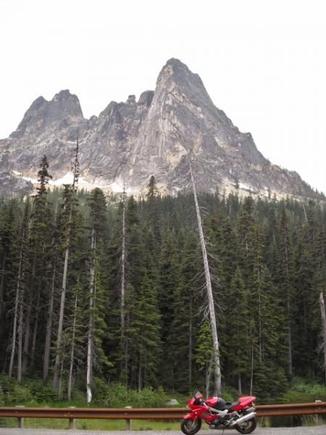 Liberty Bell Mountain towers over Washington Pass. The mountains in the area are all made of gold colored granite.