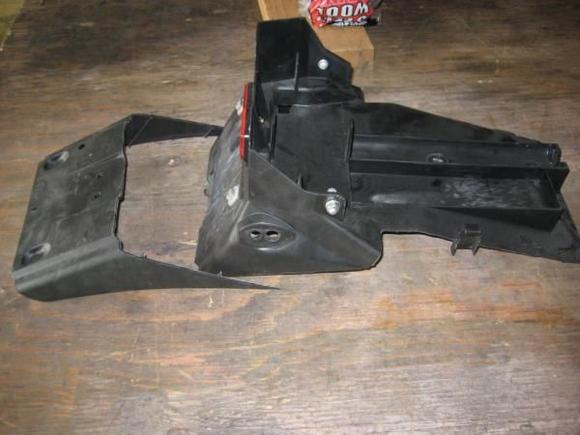 removed portion of seat undertray, shows mud flap cut off