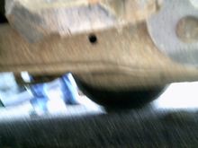 Bent rear trailing arm on pass. side.