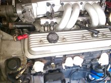 5.7L 350 motor I started with.  Worked the shopping list with Sofakingdom.  He was a huge help.  Block/heads are powder coated black, intake, valve covers and pulleys are powder coated candy burgundy.  TPI plenum, fuel rails, and Runners are polished aluminum.  I will attempt to get a shot of the new motor and post