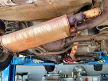 The original exhaust was restrictive (even with the holes!) and quite fugly. Also, the leaks made driving with the windows up unpleasant and dangerous.
