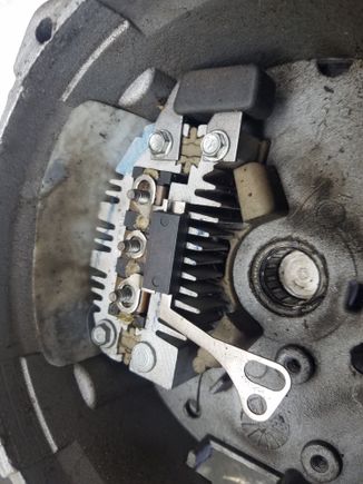 Remove the three bolts here and the but on the back that screws to the battery lug.