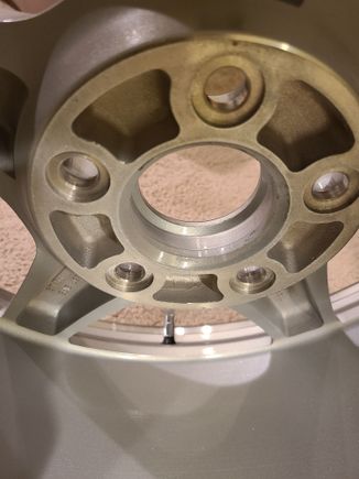 Showing where material is removed for weight savings. Also you can see there is some sort of raised piloting ring in the hub, but the finish on it doesnt make it look terribly precise, which makes me wonder even more if these wheels are really only intended to be lug centric, and maybe the pilot is just for lining things up prior to properly torquing the lugs...