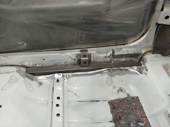 Passenger side SFC hammered in with the seat belt anchor unwelded.