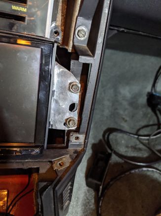 to get it in position I had to reach under the radio and push up as I got the screws tight
