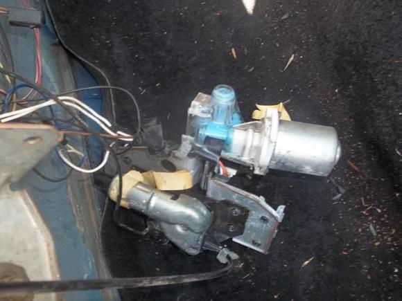 This is the motor, its still all plugged in. Looks like all the wires are still plugged in. When i click on the middle console button release, all i hear is a click. How can i tell if the motor is still good? And where can i get replacement parts?