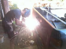 my cousin welding on the D rings on my bumper... he is wearing flip flops