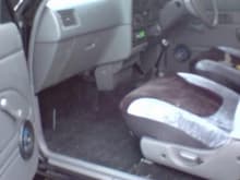 Interior, recently fitted luxury of a carpet in black, and seat covers, soon to be heated electric leather seats from a donor vehicle in a salvage yard someplace, and a leather and chrome steering wheel also to be added