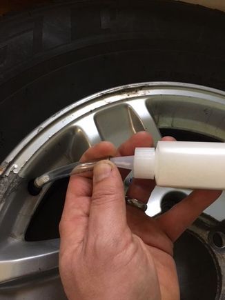 Pour beads from bottle into tire with included tube.