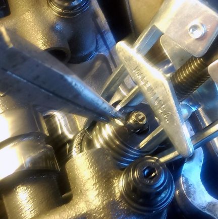 VERY CAREFULLY pulling out the keepers while the cylinders have compression.....you don't want to accidentally drop a hardened keeper into the motor!