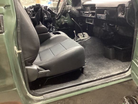 Picture of the standoff distance between the seat and floor prior to modification.